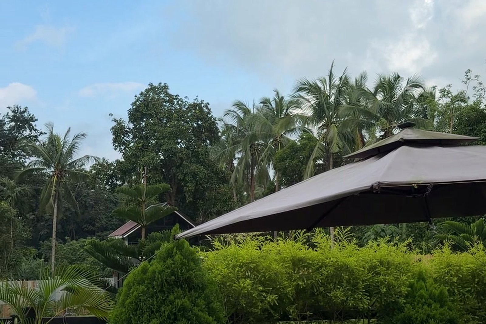 Garden gazebo with cottage roofs in the distance