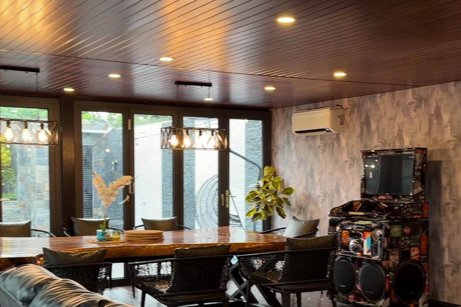 Indoor dining and lounge area with wood-panel ceiling