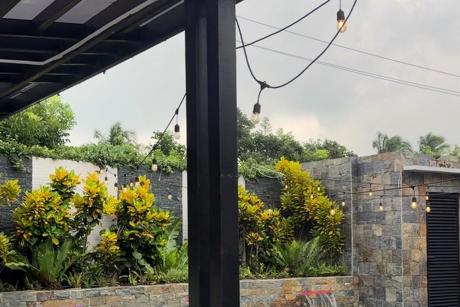 String lights over the pool deck garden wall