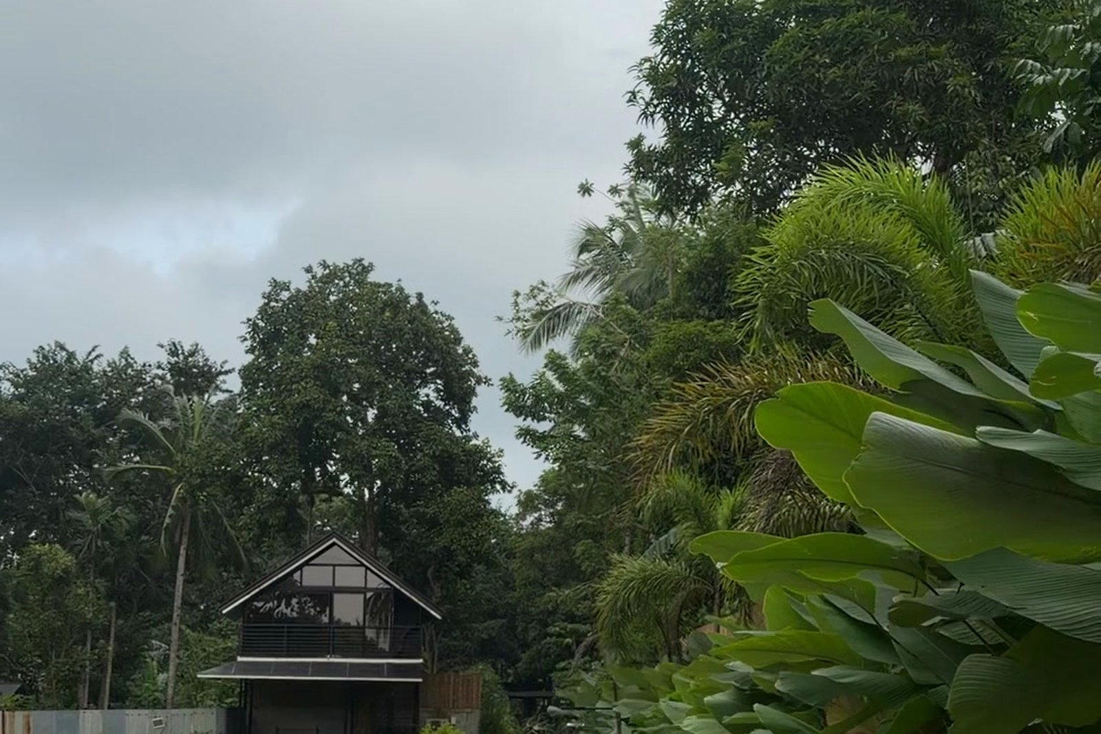 A-Frame Villa seen across the lawn under overcast sky